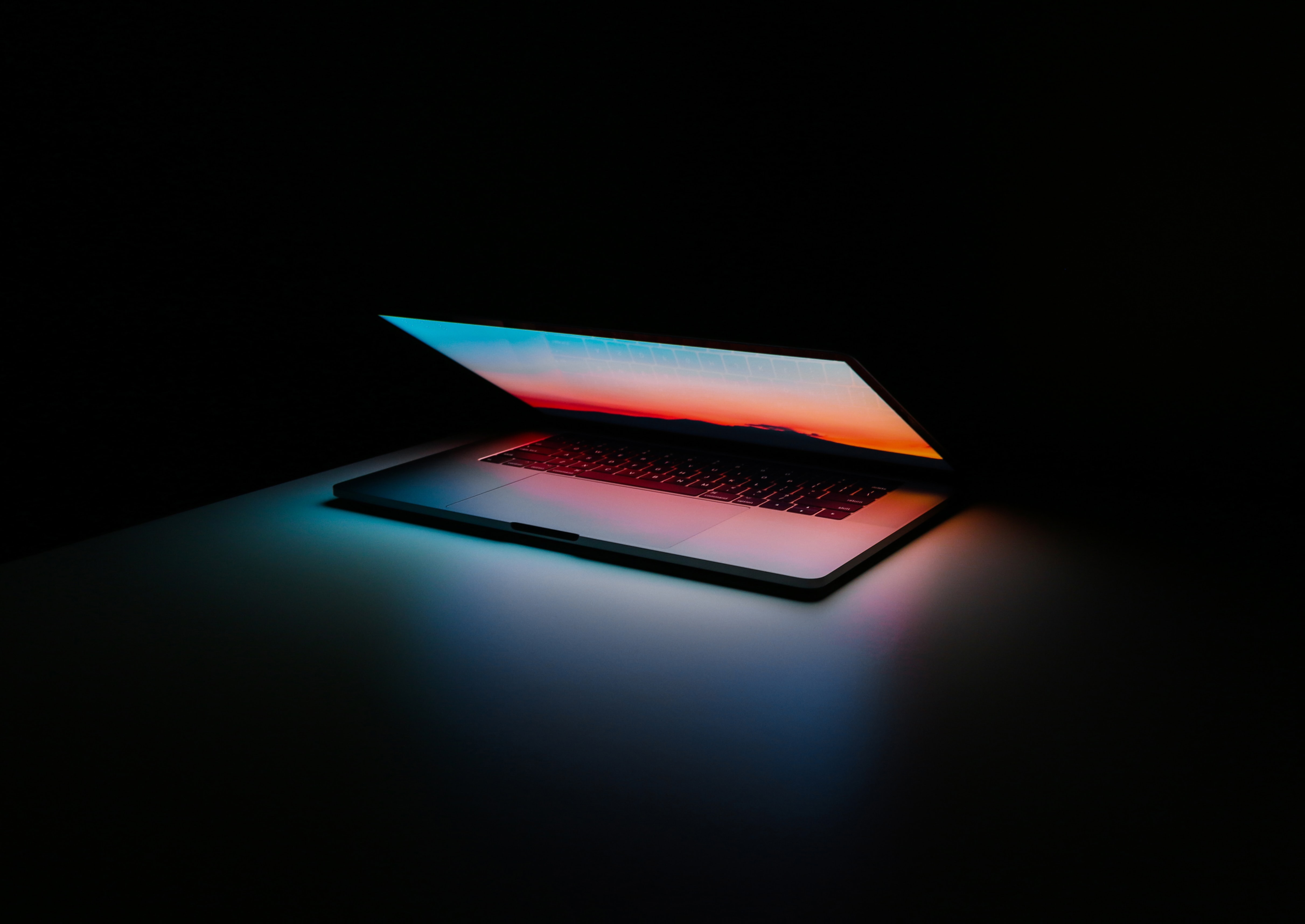 Laptop on the black background. Photo by Ales Nesetril